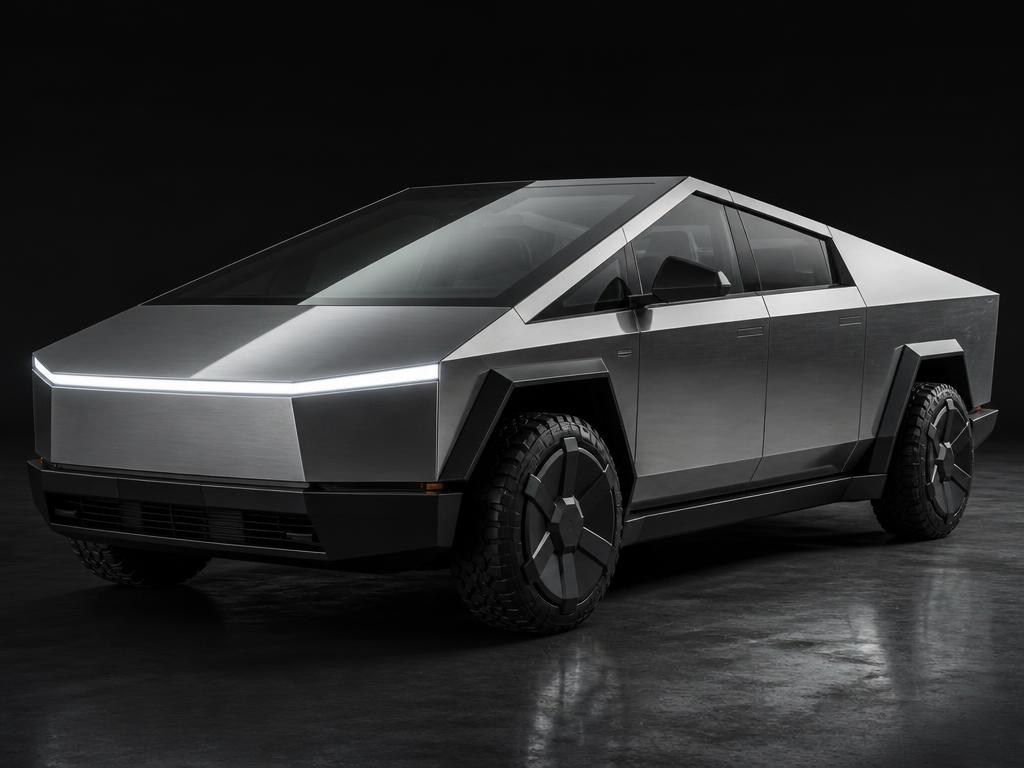 Angular stainless steel Tesla Cybertruck pickup in a dark studio